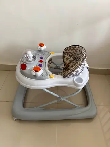 Lightweight baby walker with detachable toys and canopy - good condition