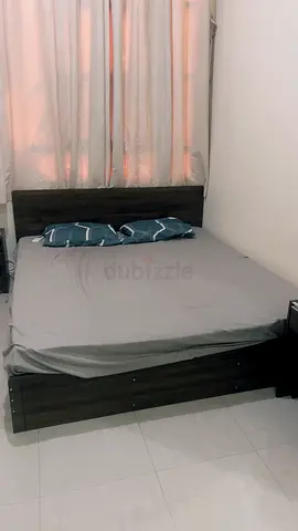 dark wood bed, mattress, bed side, dressing table with mirror and stool