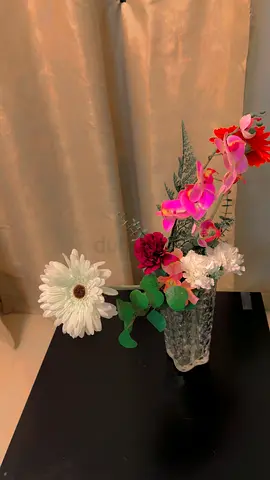 Artificial flower arrangement in glass vase - decorative centerpiece