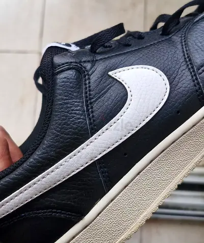 Black leather sneakers with white swoosh - good used condition