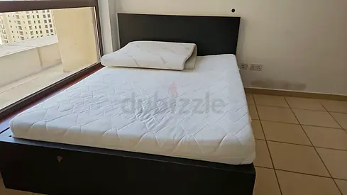 Queen wooden bed frame with mattress and pillow — good condition