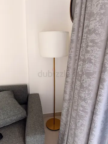 Slim gold floor lamp with white drum shade - good condition