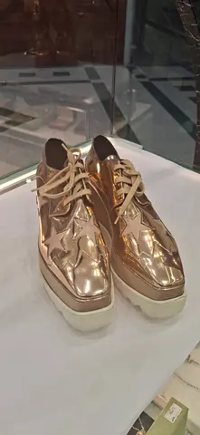 Womens metallic rose gold platform sneakers, size unknown - good condition