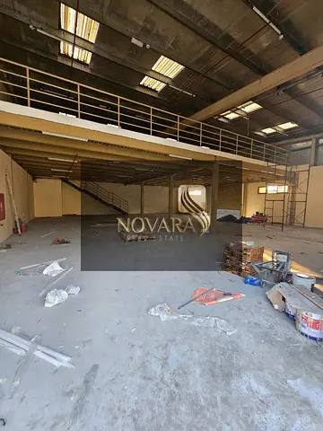 A new warehouse for rent in Al Jurf Industrial Area 1, Ajman, 6,000 sq ft with a mezzanine, 25 kW electricity, rent AED 310,000
