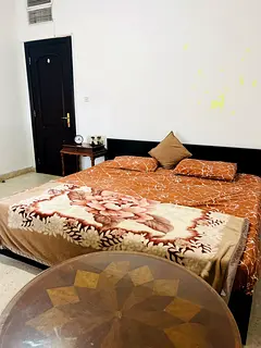 Spacious room with wall mounted wardrobe and furnished