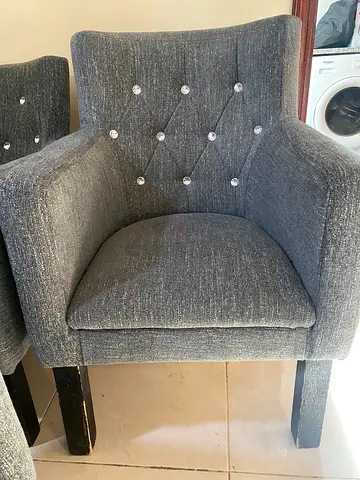 Style: Grey Upholstered Armchairs with Crystal Buttons.
• Quantity: 8 Chairs.
• Price: AED 35 per ch