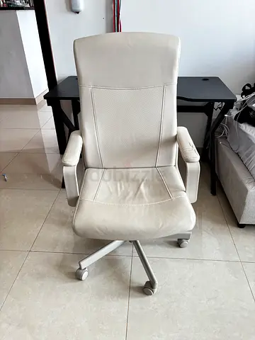 White ergonomic office chair with adjustable tilt and armrests