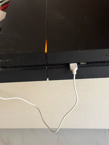 Sony PlayStation 4 Slim console - used, working with 2 controllers and 2 games