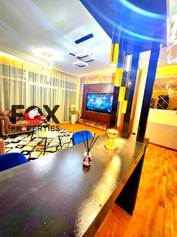 Two-bedroom apartment and a living room for sale in Al Rashidiya 1 - Horizon Towers. The apartment features a balcony with a sea view, good ventilatio