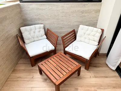 Wooden balcony seating set — 2 chairs with cushions + small table