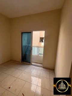 Two-bedroom apartment with a living room, fully renovated, for annual rent in Ajman for employees.