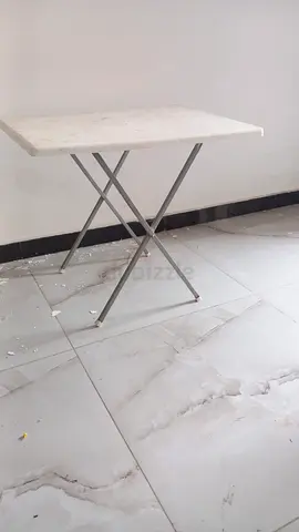 Small foldable marble-top table with metal legs