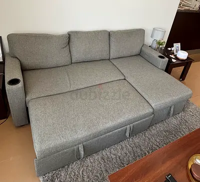 Grey fabric L-shape sofa bed with chaise and cup holders - great condition