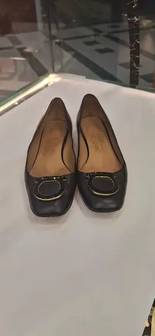 Used womens black leather flats with gold buckle, size approx. 38