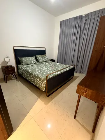 Customised King-size bed with brass frame and dark grey upholstered headboard (without Mattress).