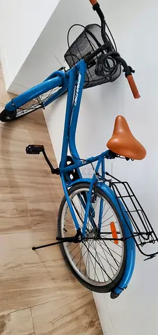 Blue city/commuter bike with basket and rear rack — good condition