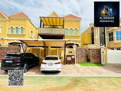 Villa for sale in Al Muwaihat area, Ajman, steps away from the school complex and the Saudi German Hospital. Includes electricity, water, and air cond