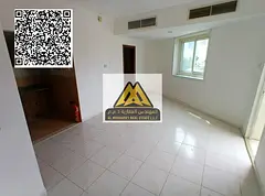 A studio for annual rent in Al Rashidiya 3 – Ajman, featuring a balcony, built-in wardrobes, a sep
