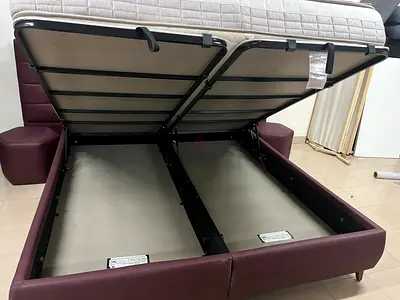 A modern hydraulic bed with an upholstered design and offers ample internal storage space.