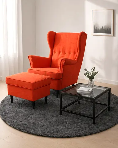 a cozy and comfortable soft chair with a footstool