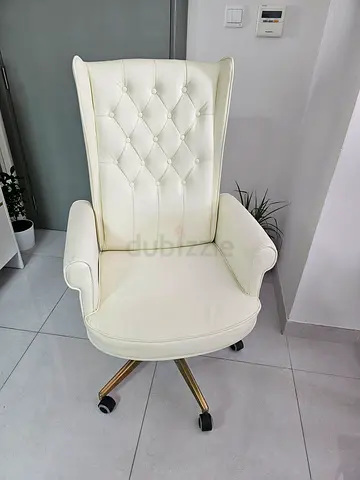 White tufted high-back office chair with castor wheels