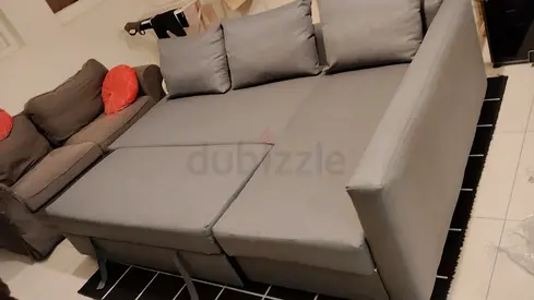 Light grey fabric L-shaped sofa bed – converts to large bed, good condition