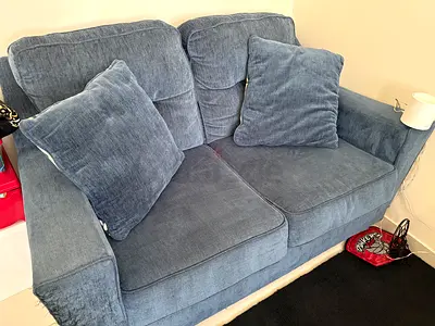 Two-seater blue fabric sofa in excellent condition