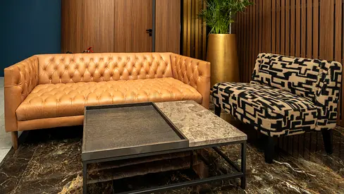 Leather Chesterfield Sofa and Patterned Accent Chair with Marble Coffee Table