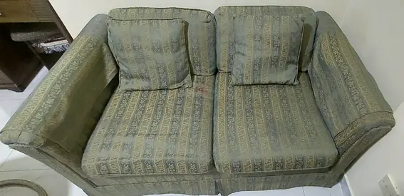 Two-seater patterned fabric sofa — good condition