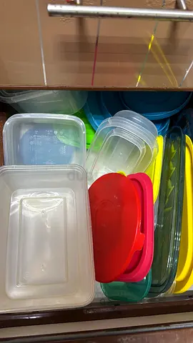 Set of assorted plastic food storage containers with lids, plates, stand