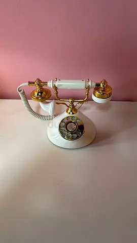 Vintage rotary corded telephone in white and gold