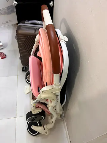 Foldable pink baby stroller - compact and lightweight