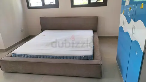 Modern low-profile upholstered double bed frame with mattress