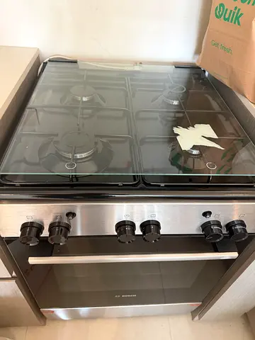 Used stainless steel gas cooker with oven - 4 burners, good condition