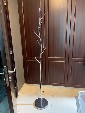 Free-standing metal coat rack with wooden tips - good condition