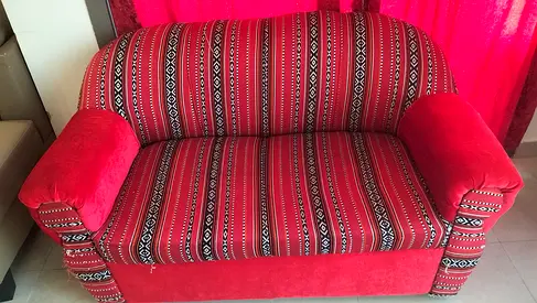 Two-seater red patterned sofa in good used condition