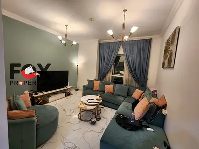 A bedroom and living room for sale in the Rashidiya area in Al Waha Towers, with an area of 860 square feet. Sold furnished and ready to move in.