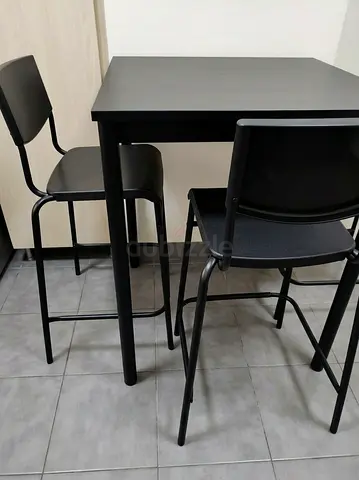 Used black bar-height table with three matching bar stools — compact set