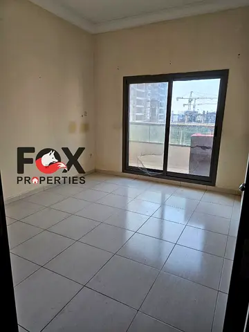 Two rooms and a living room for annual rent in Emirates Towers,with free parking,balcony,2 bathrooms, Near to Dubai exit, on Mohammed bin Zayed Street