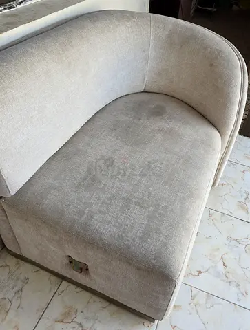 Light beige two-seater curved sofa - used