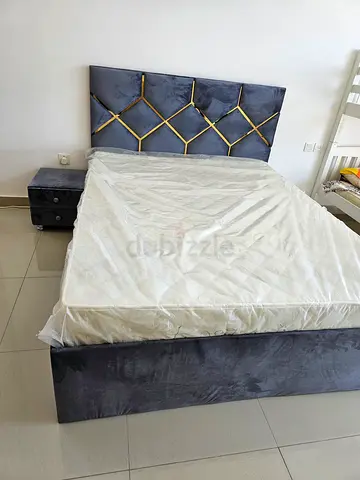 Queen bed with storage underneath and side table