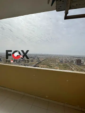 Room and hall for annual rent in Ajman, in City of Emirates, with a balcony, master room,2 bathrooms,spacious areas,directly on Mohamed Bin Zayed Road