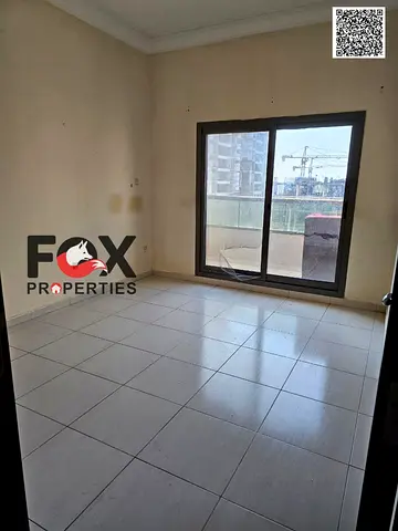 Two bedrooms and a living room for annual rent in Ajman, Emirates Towers, with a balcony and open view.