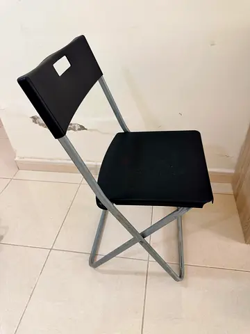 Foldable metal-frame stool with black seat — compact and portable
