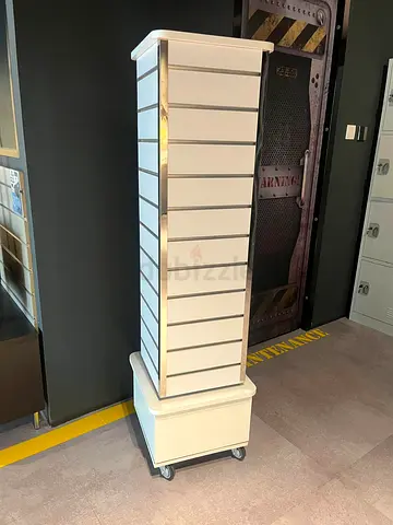 White rotating slatwall display stand on wheels