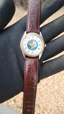 vintage Rotary watch features a Saudi Air Force emblem on the dial, a fluted bezel, and a date displ