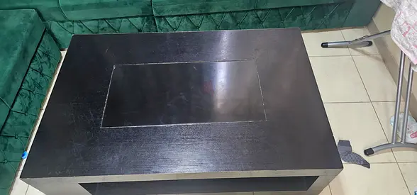 Used black rectangular coffee table with lower shelf