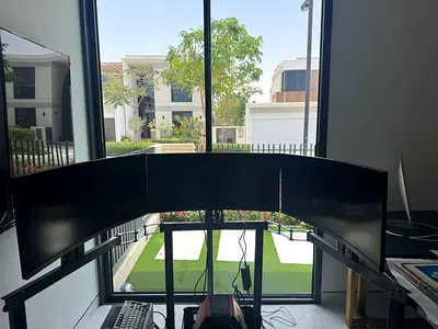 Triple curved monitor setup on adjustable stand - used