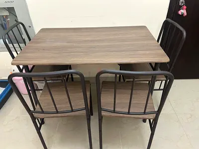 4-seater wooden dining table with metal frame