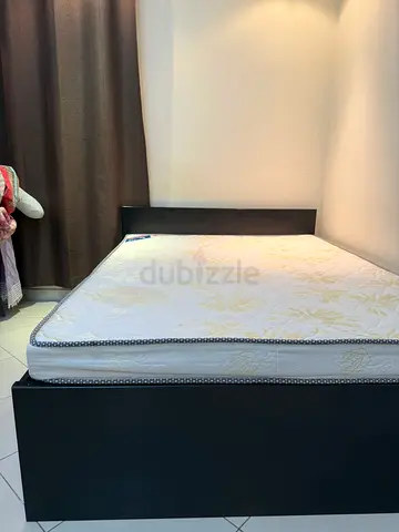 Queen size black platform bed with mattress and storage facility. Very  good condition.
